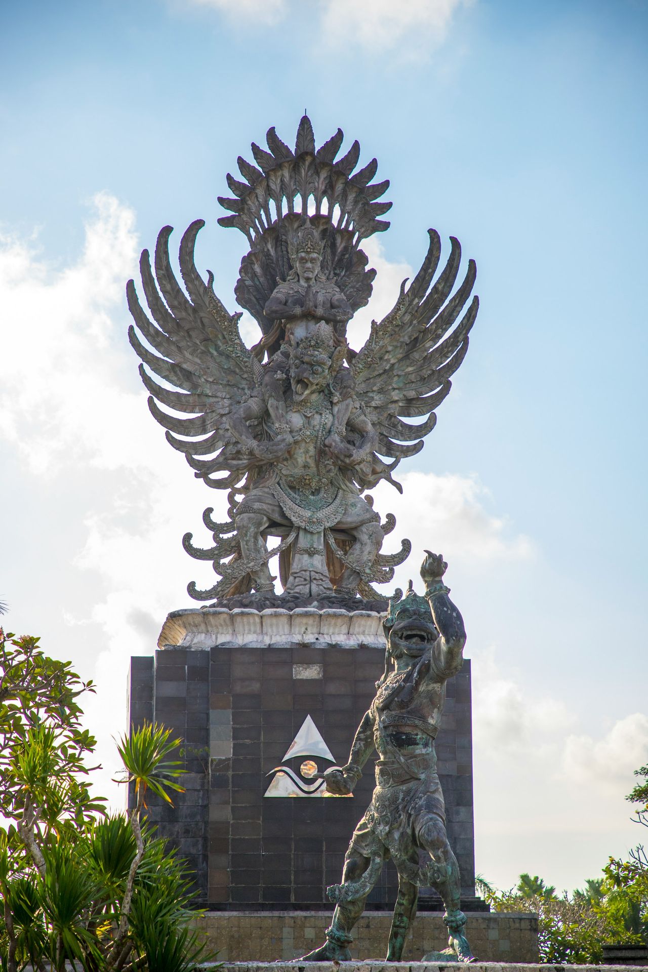 a statue of a person holding a staff